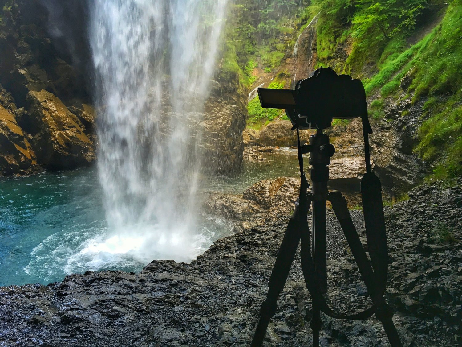 camera on a tripod at a waterfall nature photography